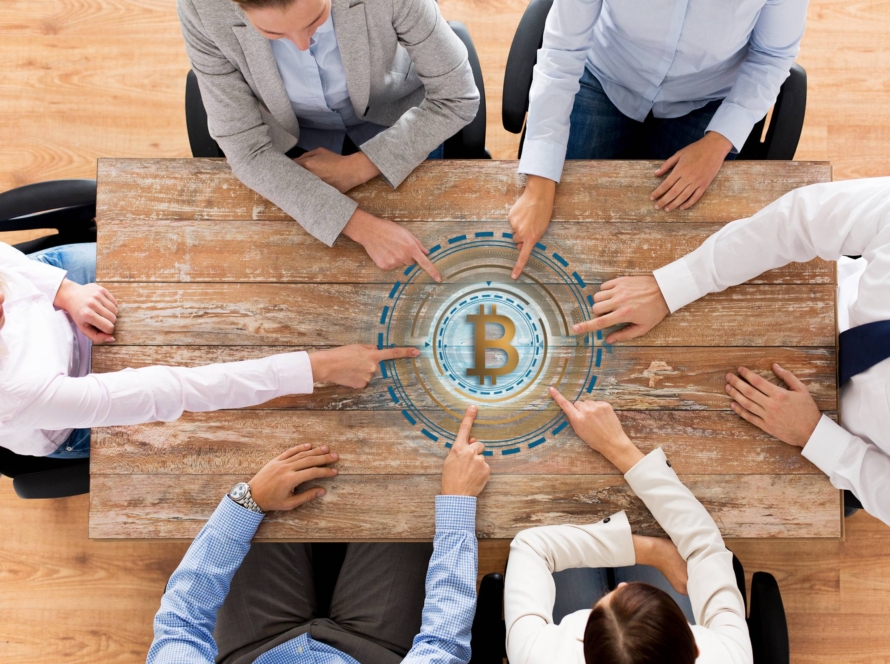 business team table with bitcoin icon 1